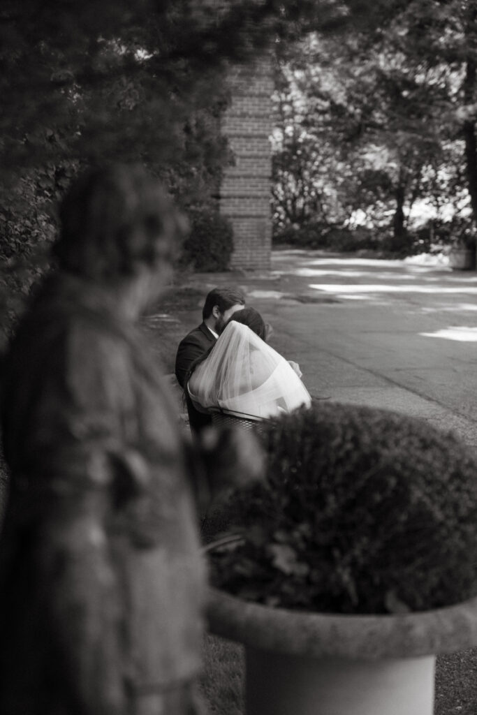 Black and white photo of couple sharing a quiet kiss during their Ohio garden wedding at Kingwood.
