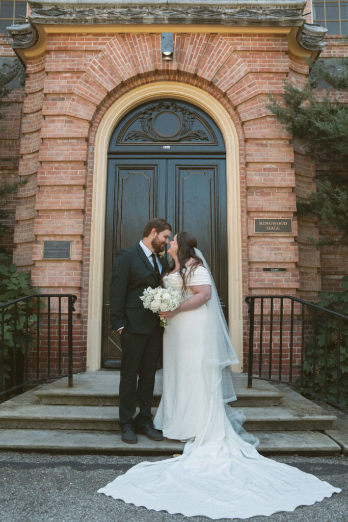 Bride and groom share a quiet moment on the steps of Kingwood Hall during their Ohio garden wedding.