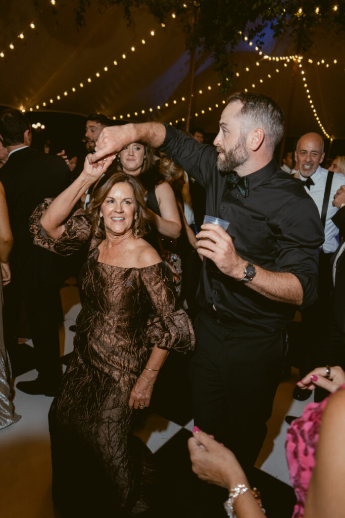 mother of the groom dancing with another wedding guest
