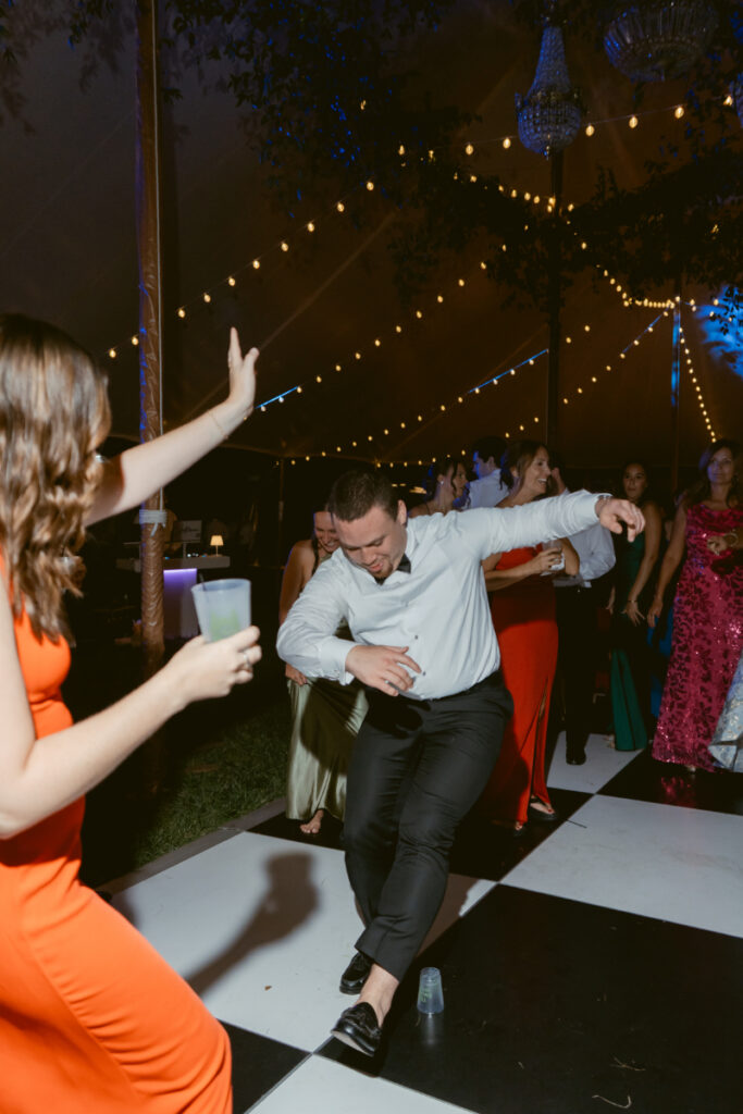 wedding guests dancing with lights overhead
