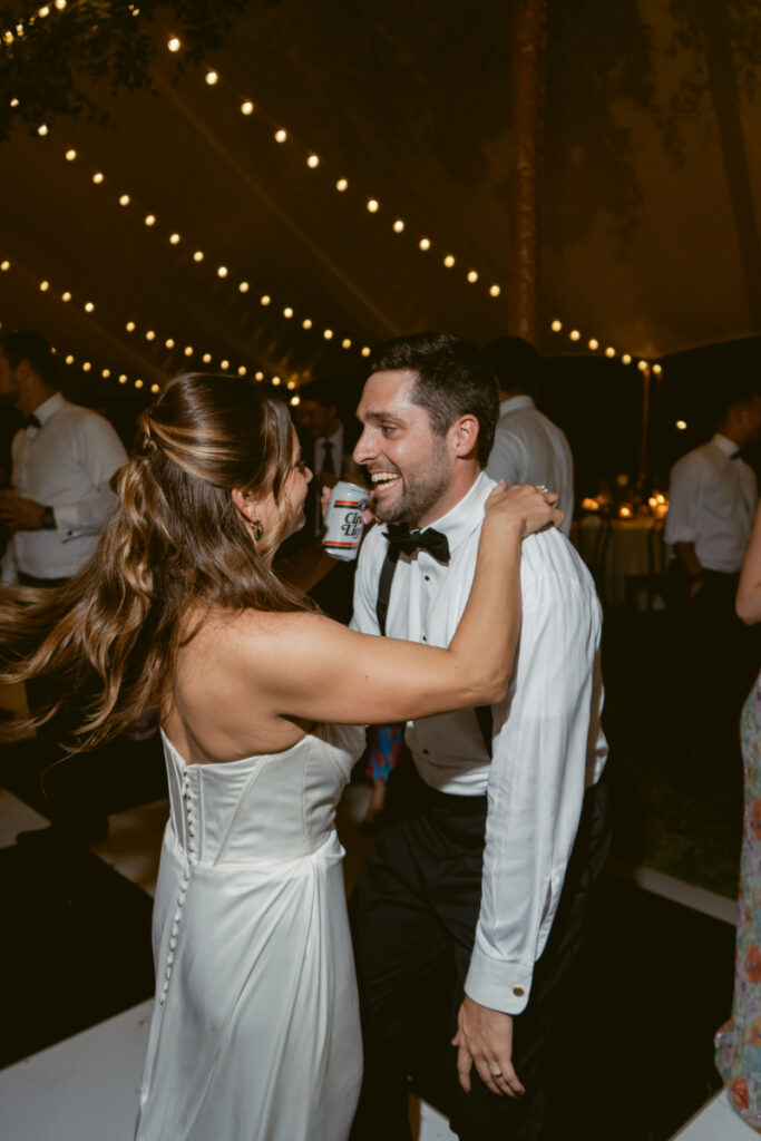 bride and groom laughing and dancing on their wedding day