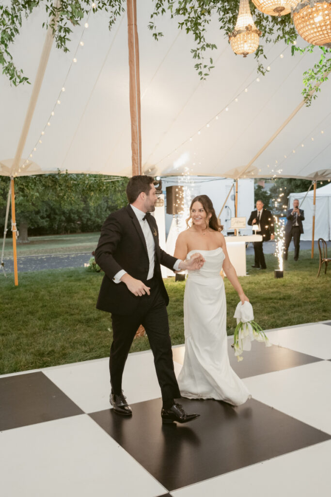bride and groom make their entrance to the wedding and share their first dance
