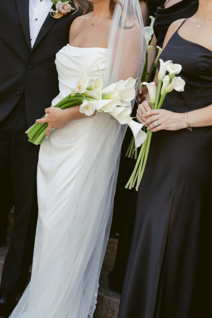 Bride and bridesmaid hold elegant white calla lily bouquets at Laurel Court wedding in Cincinnati.