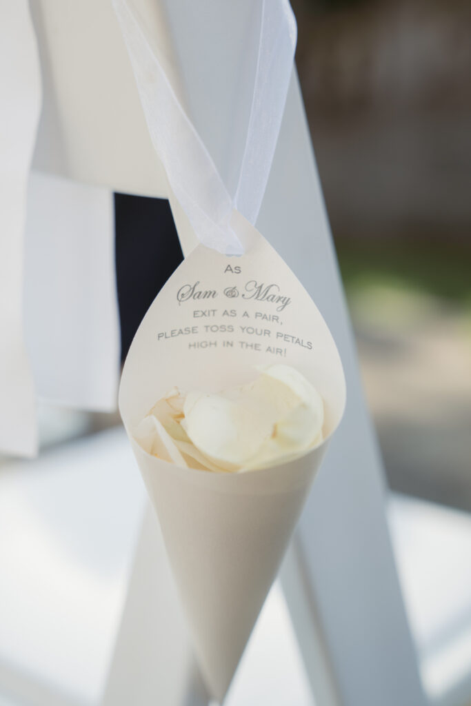 Cone of white rose petals hanging on chair for Laurel Court wedding ceremony exit toss in Cincinnati.
