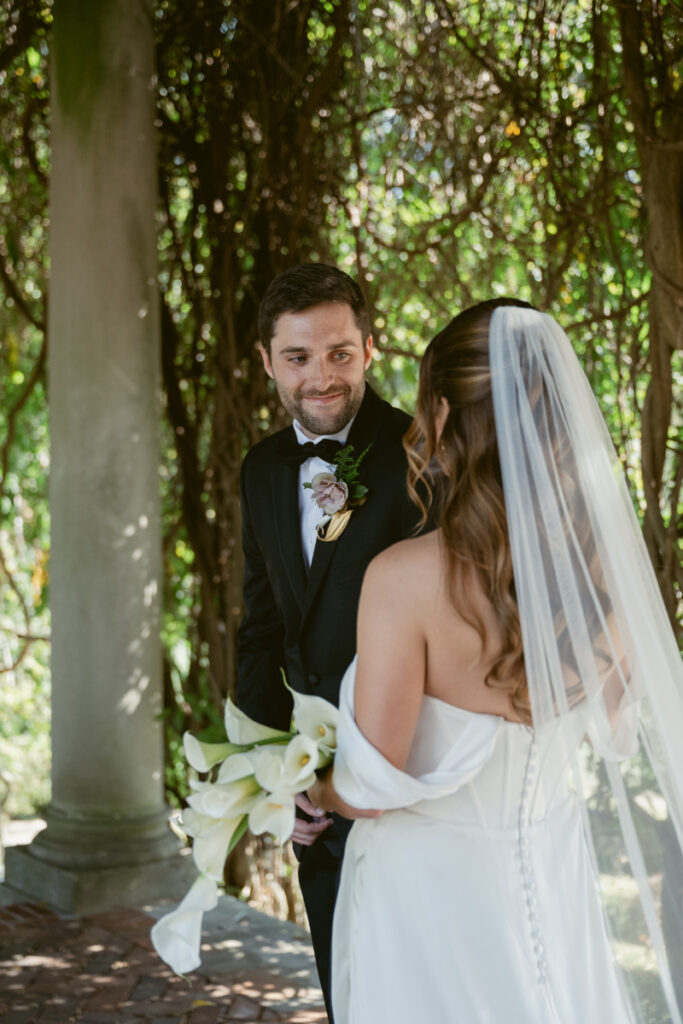 Groom smiling at bride during emotional first look at their Laurel Court wedding.