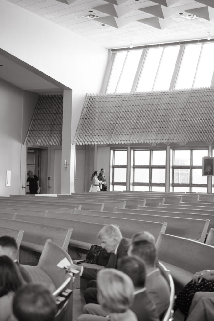 Bride entering the church as guests look on during a Laurel Court wedding weekend ceremony.