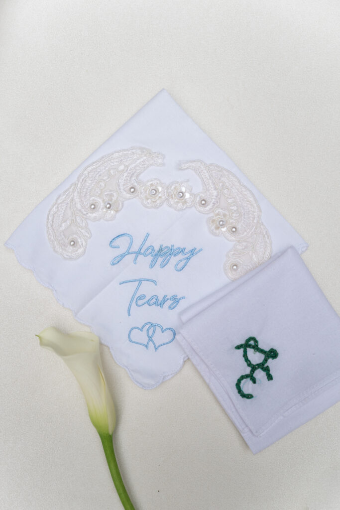 Embroidered wedding handkerchiefs and calla lily styled for a sentimental Laurel Court wedding detail.