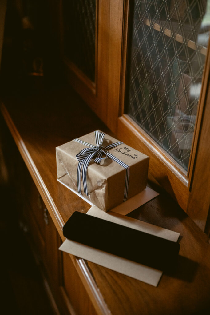 Wrapped gift and card waiting for the groom during a Laurel Court wedding morning.