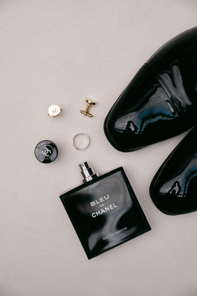 Groom’s accessories and cologne styled for flat lay before a Laurel Court wedding.