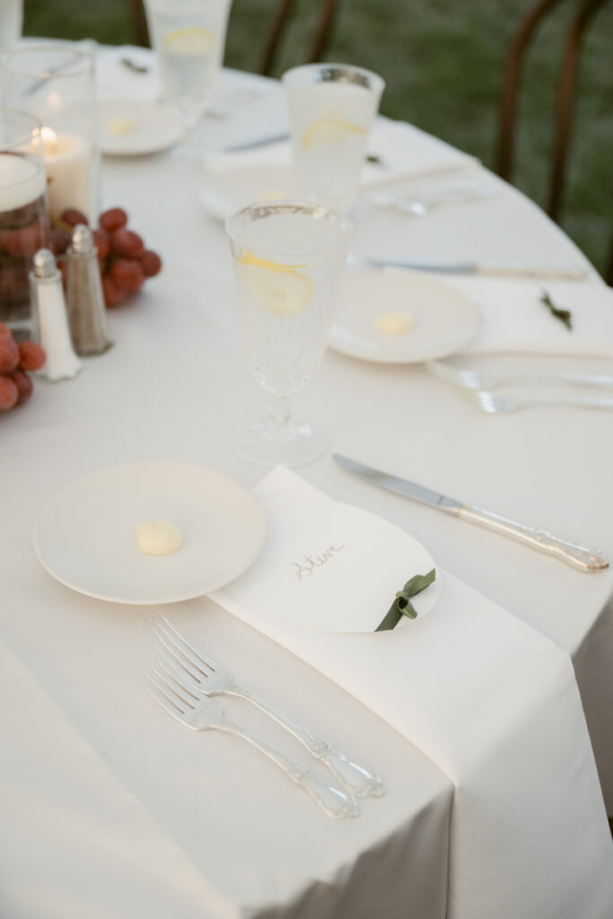 elegant wedding reception with white linens candles and red grapes