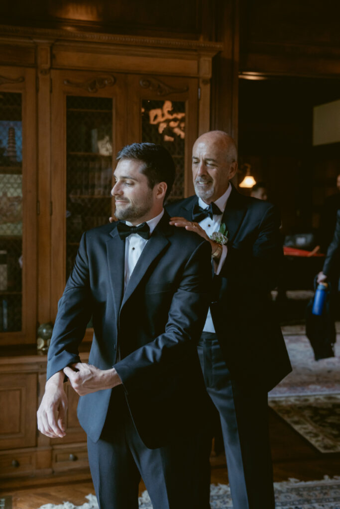 Groom getting ready with his father in a library room before the Laurel Court wedding.