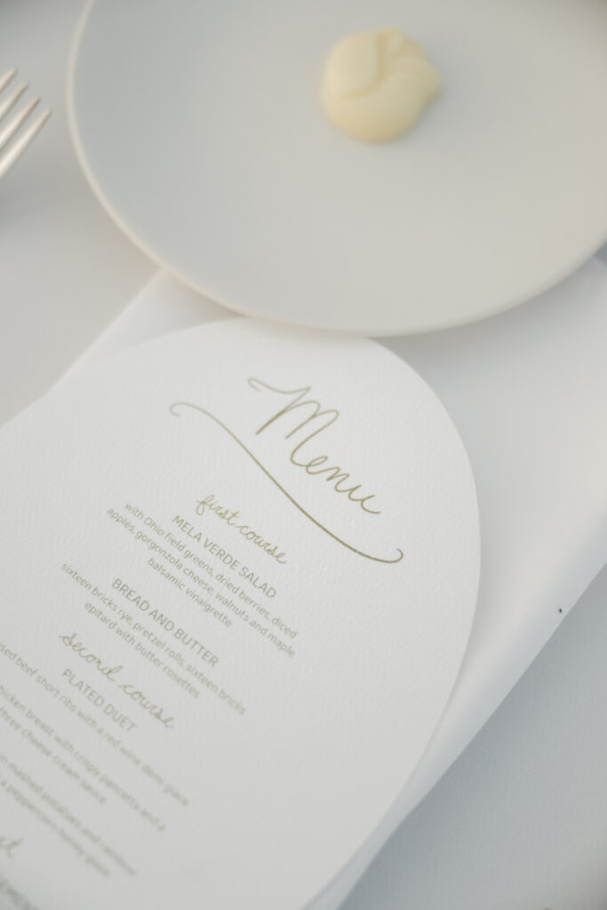 Close up of wedding dinner menu with white linens