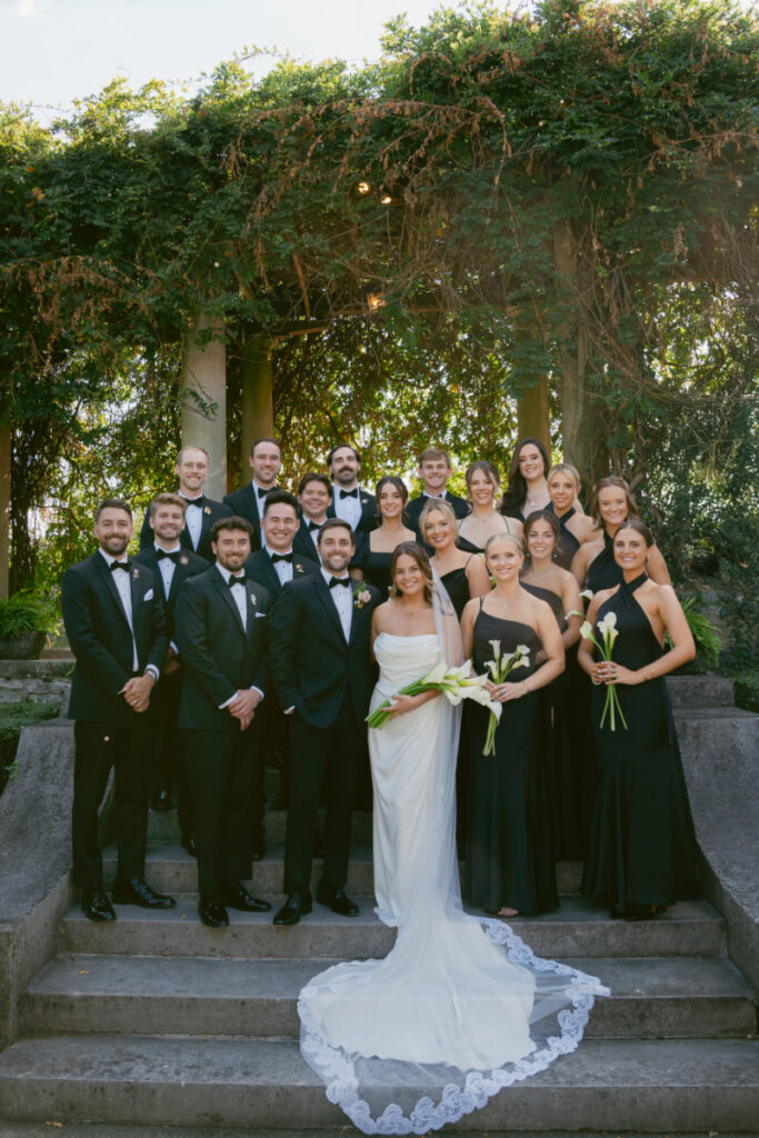 bride and groom pose with their bridal party at a Laurel Court wedding