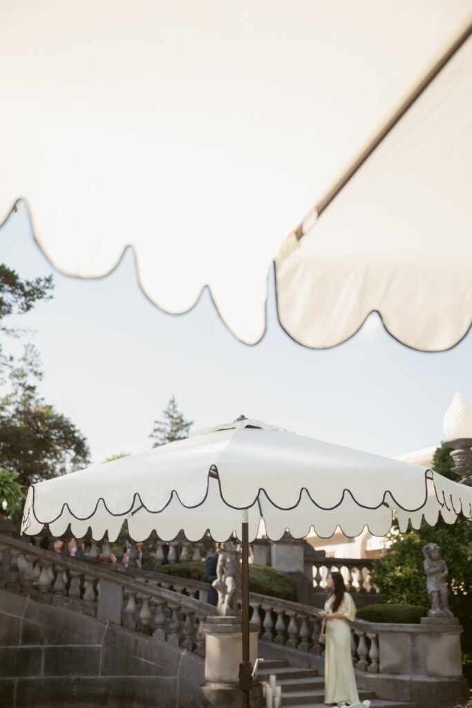 white umbrellas with stone steps in the background