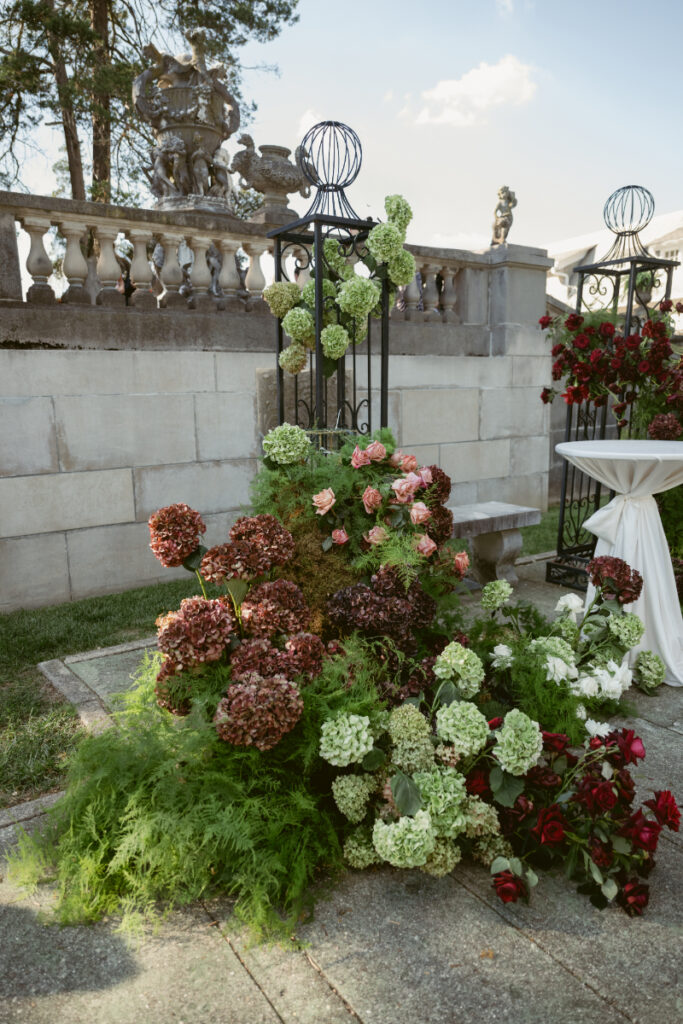 lush flowers with stone walls in the background at a Laurel Court wedding