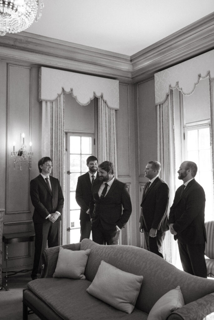 Groom shares a laugh with his groomsmen in a quiet moment—classic Moments You Won’t See on Your Wedding Day.