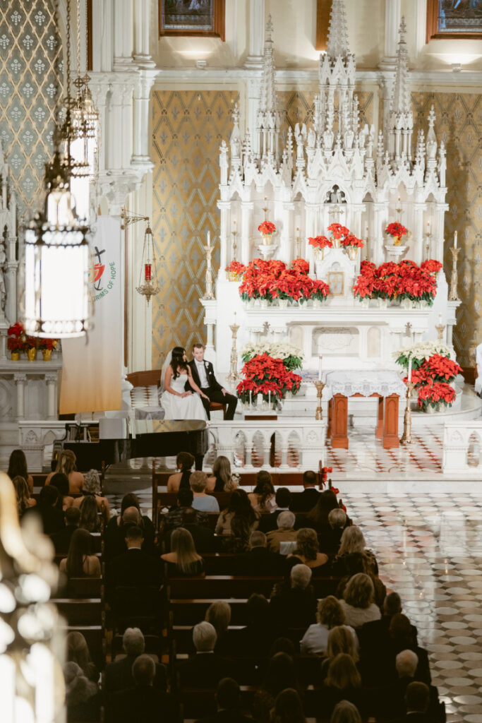 view of the church, bride, groom, and guests at a cozy Christmas wedding 
