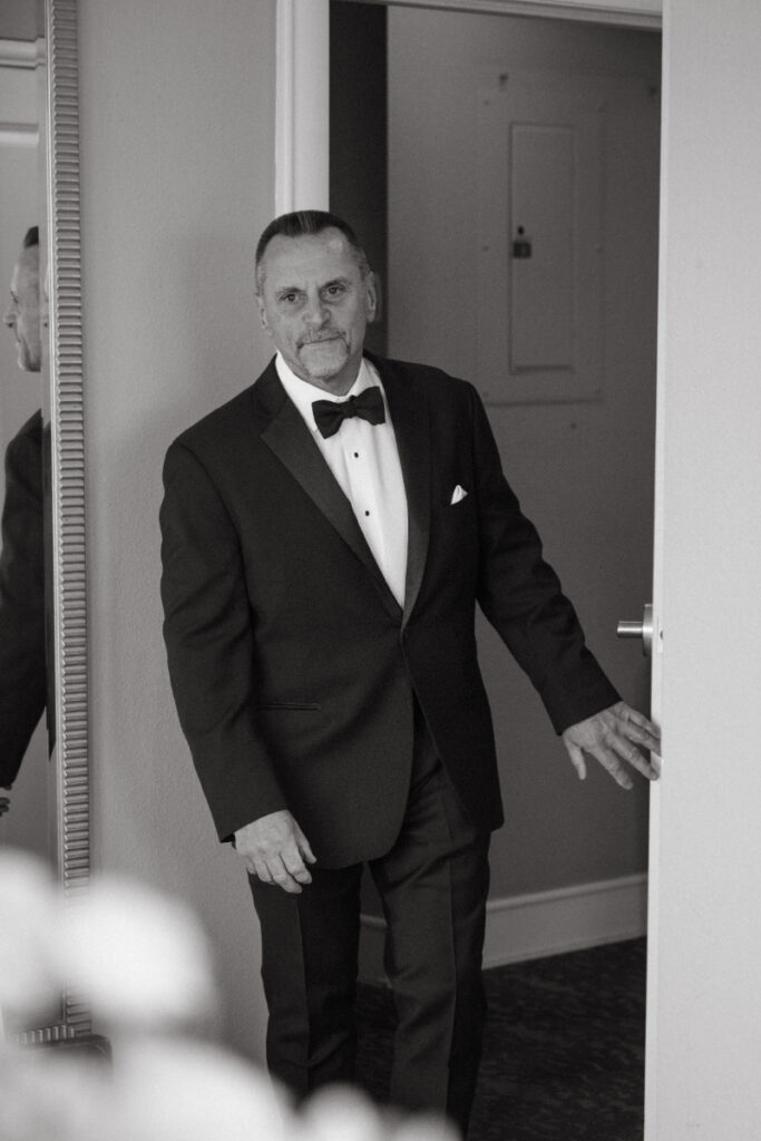 Father of the bride sees daughter for first look during cozy Christmas wedding in Cincinnati.