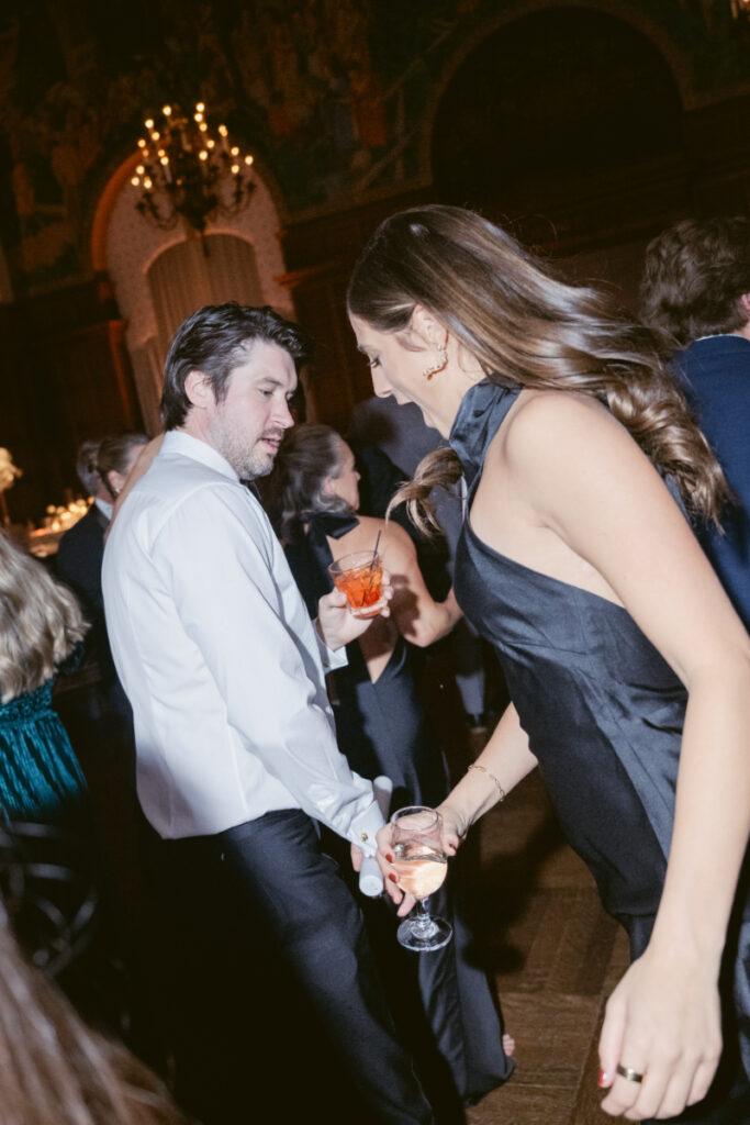 Wedding guests share a fun moment while dancing during the lively reception.