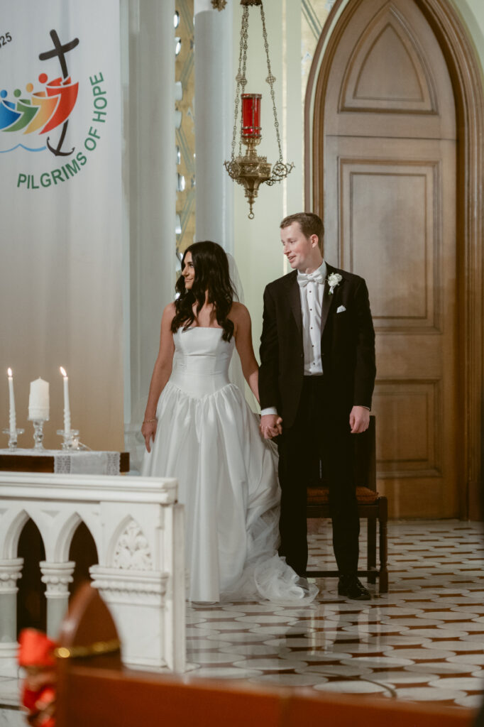 bride and groom standing hand in hand during their wedding ceremony