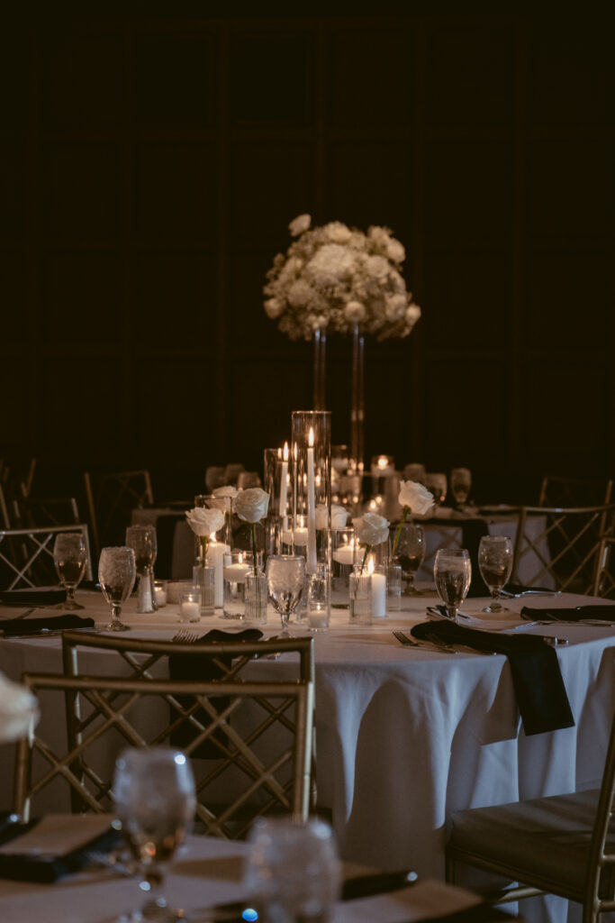 Romantic round table setup with candles and white florals for a cozy Christmas wedding.