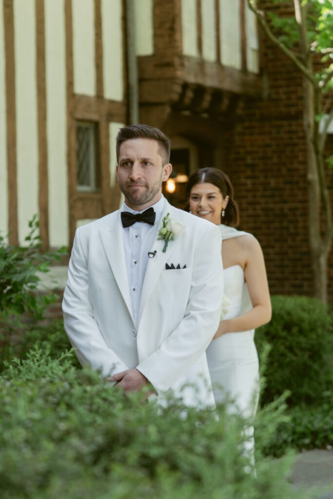 Groom waits for first look, standing in anticipation, captured by Cincinnati wedding photographer