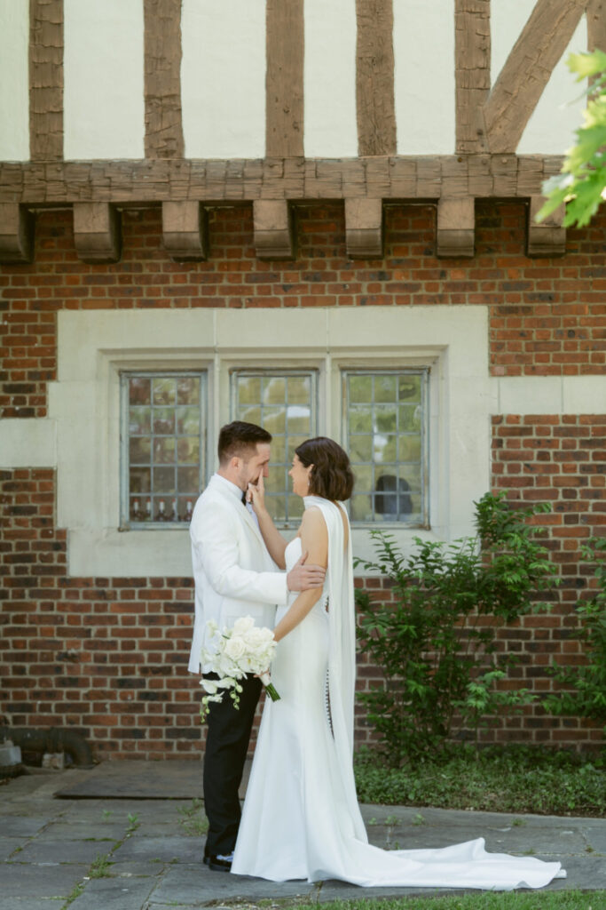 Bride and groom face each other during emotional first look, photographed by Cincinnati wedding photographer outdoors.