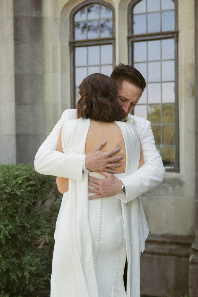 Couple embraces tightly after first look moment, beautifully documented by Cincinnati wedding photographer Kindred Light Studios.