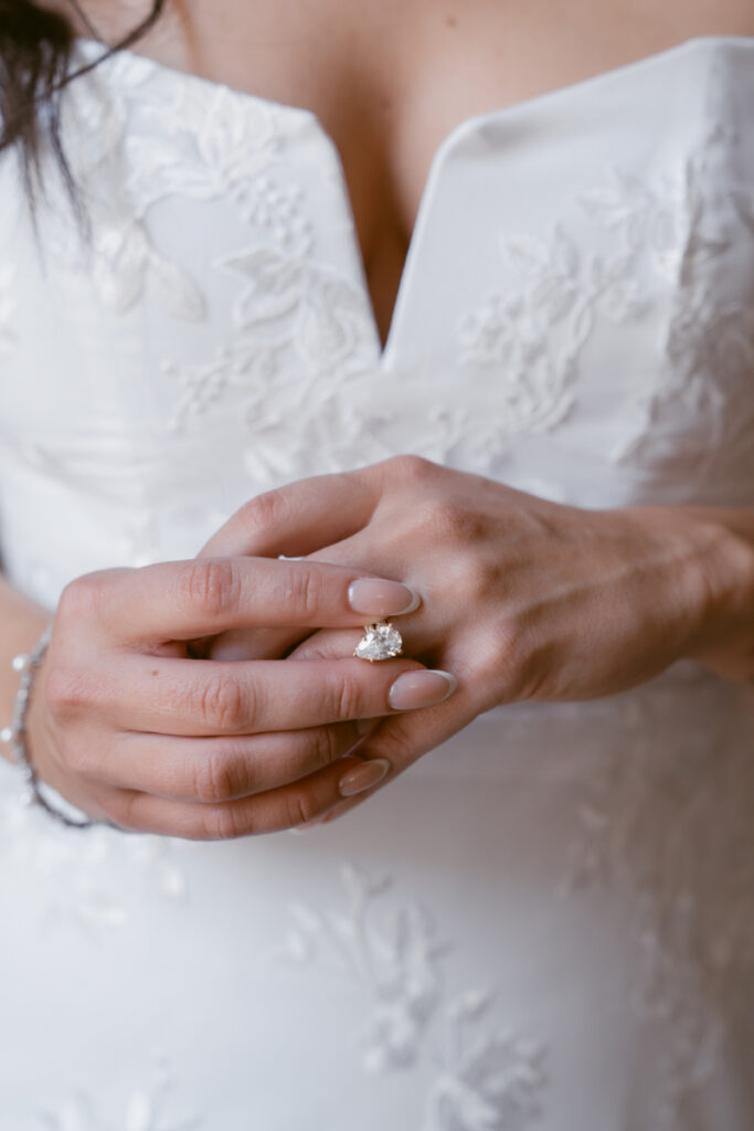 Close up of bride’s engagement ring during intimate Valentine’s Day wedding.