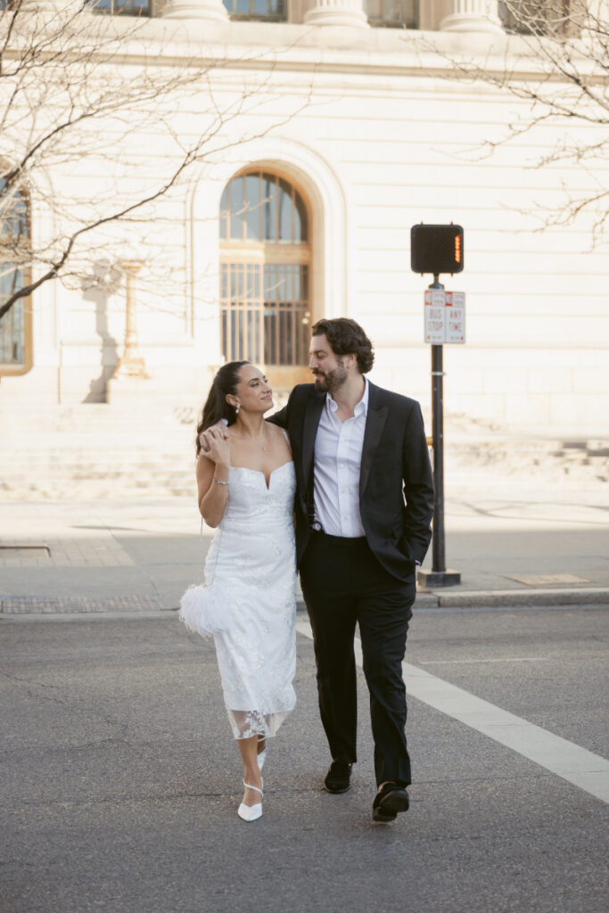 Bride and groom walking downtown after their Valentine’s Day wedding ceremony.