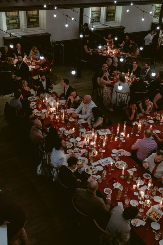 Overhead view of guests seated at candlelit reception tables.