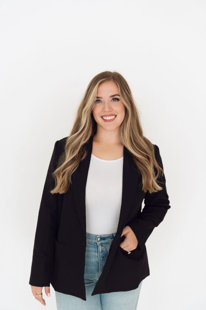 Cincinnati branding photography headshot of smiling professional woman in blazer on white background.