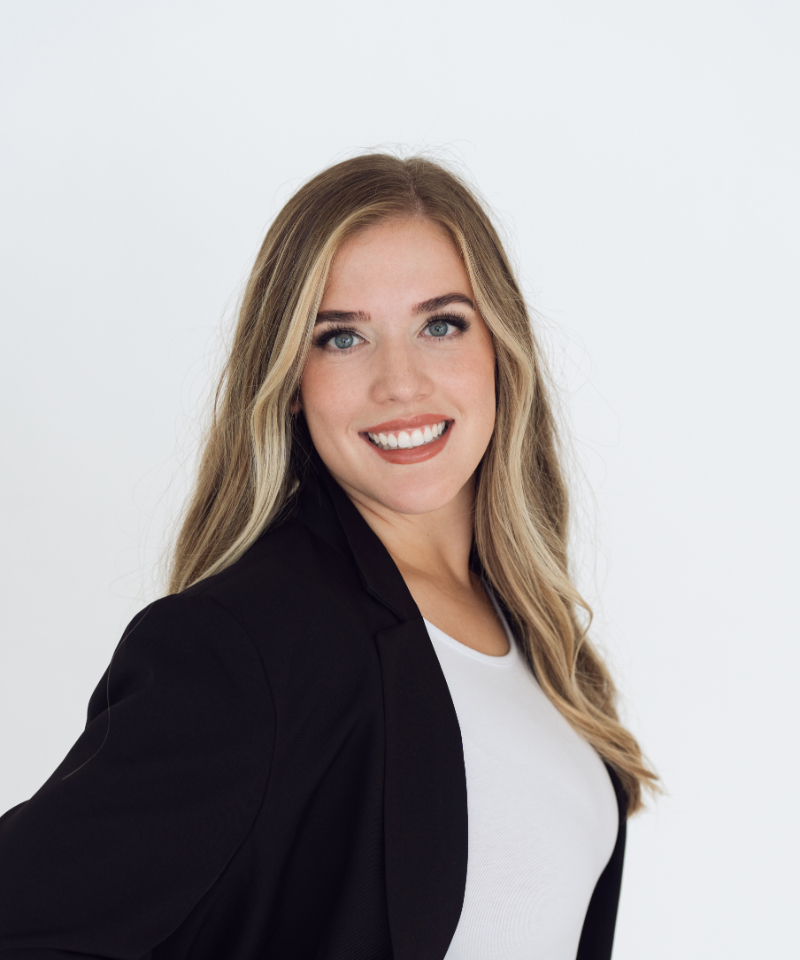 Professional photography headshots of smiling businessman in gray blazer, clean studio background.
