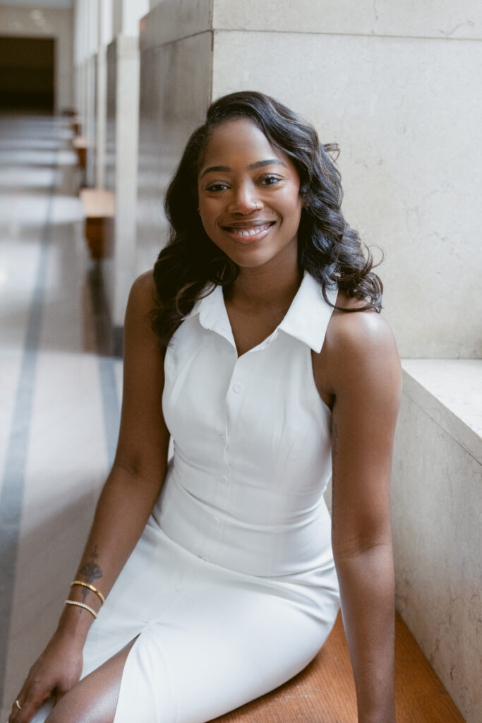Professional photography headshots of smiling businesswoman in white top, natural light setting.