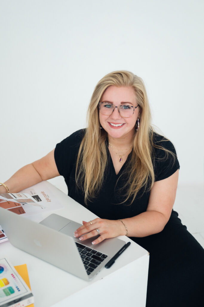 Professional photography headshots of smiling woman with laptop in bright studio setting.