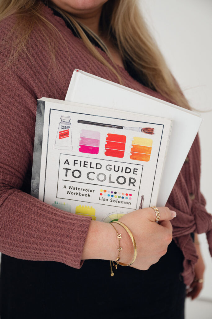 Brand photography detail of creative holding color guide book for business branding.