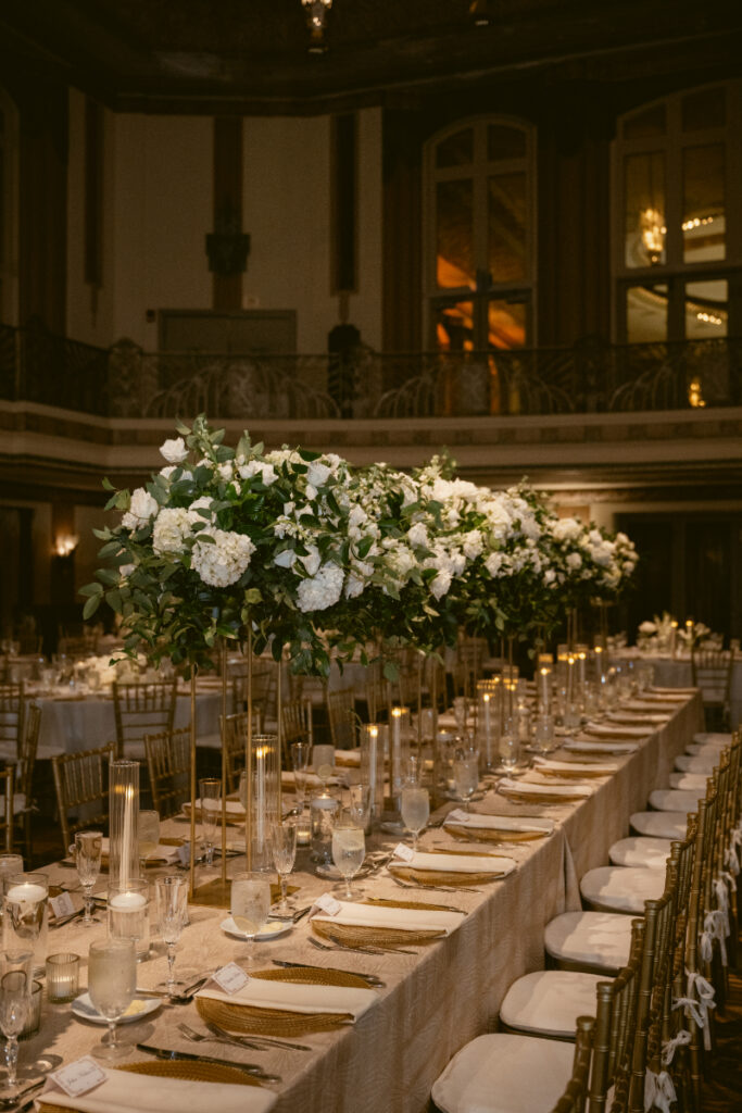 Reception space with long tables and candlelight set for the evening celebration.