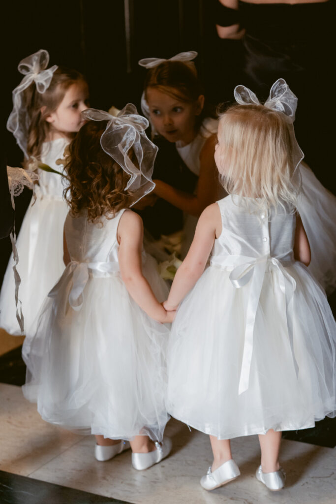 Flower girls gathered together before the ceremony at a Hilton Netherland Plaza wedding.