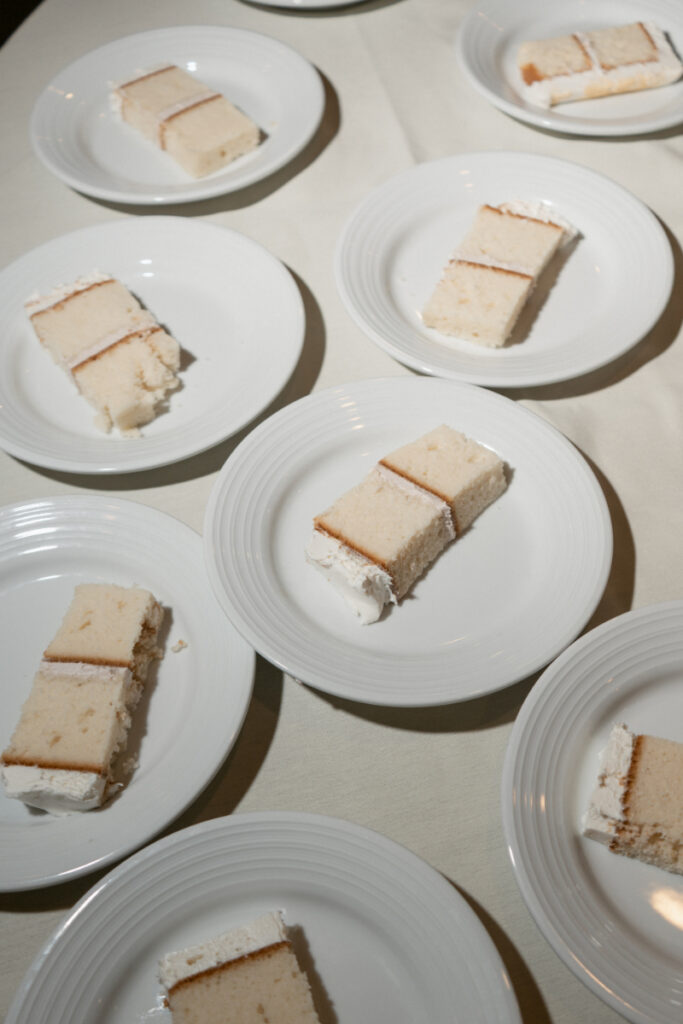 Slices of wedding cake served on plates for guests.