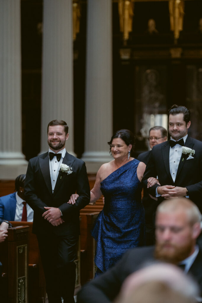 Wedding party walking down the aisle during ceremony at St. Peter in Chains for a Hilton Netherland Plaza wedding.
