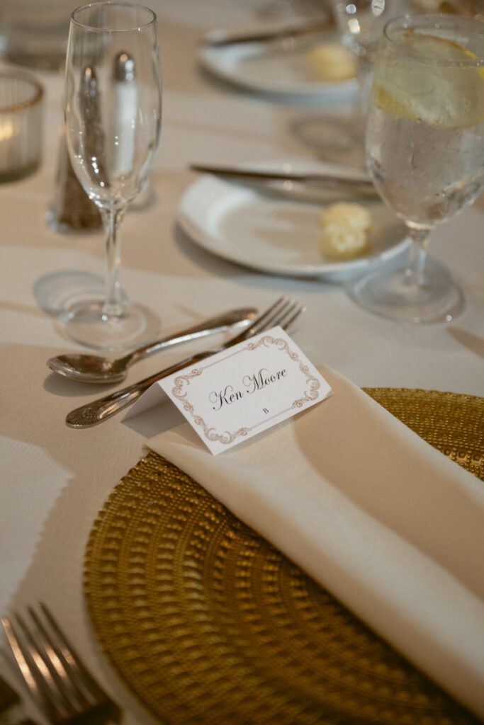 Place setting with menu card and gold charger plate.