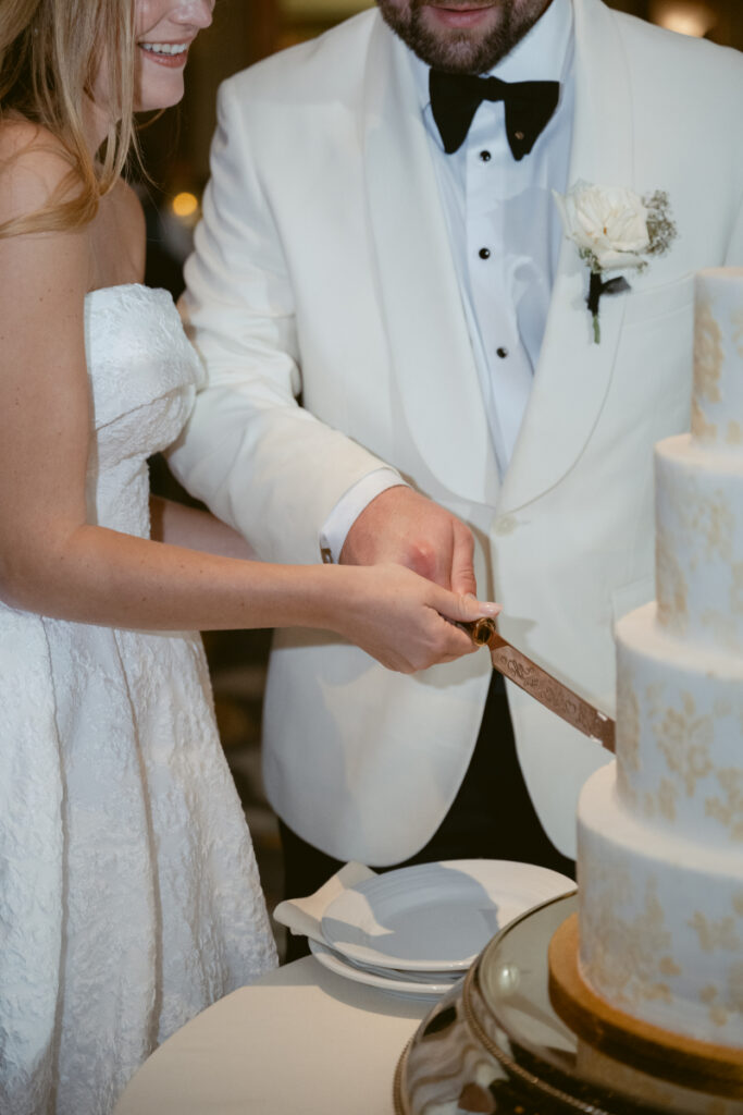 Couple cutting their wedding cake together.