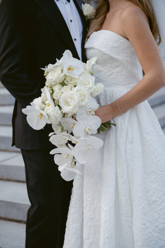 Bride holding a white rose and orchid bouquet during a Hilton Netherland Plaza wedding in Cincinnati.
