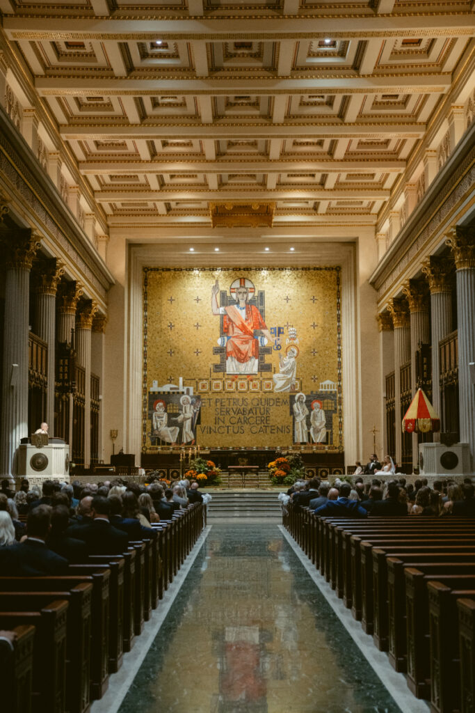 Wide view of the church interior during the wedding ceremony.