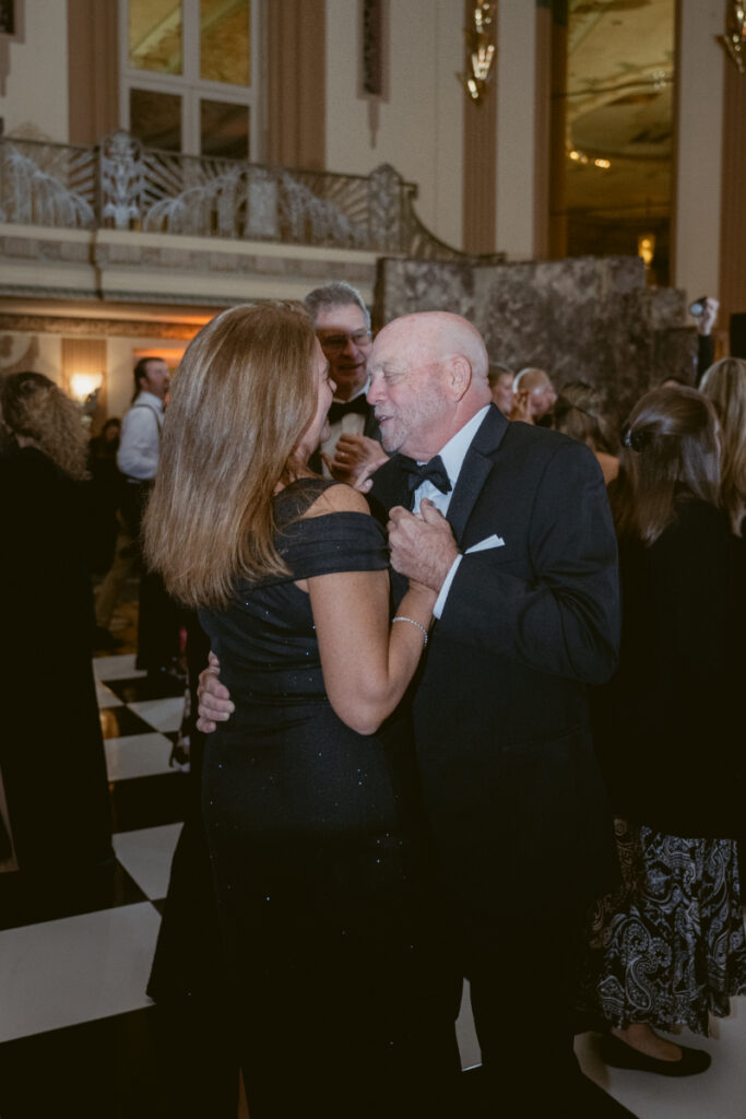 Guests laughing and dancing together during the celebration.