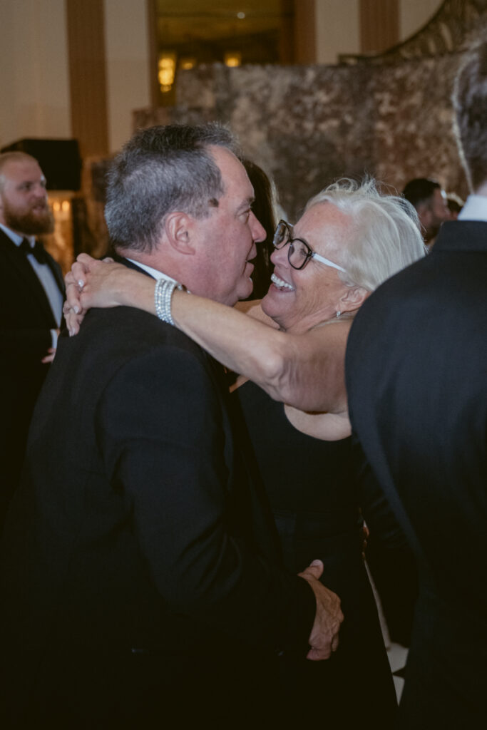 Guests laughing and dancing together during the celebration.