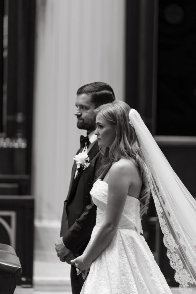 Black and white portrait of the couple standing together during the ceremony.