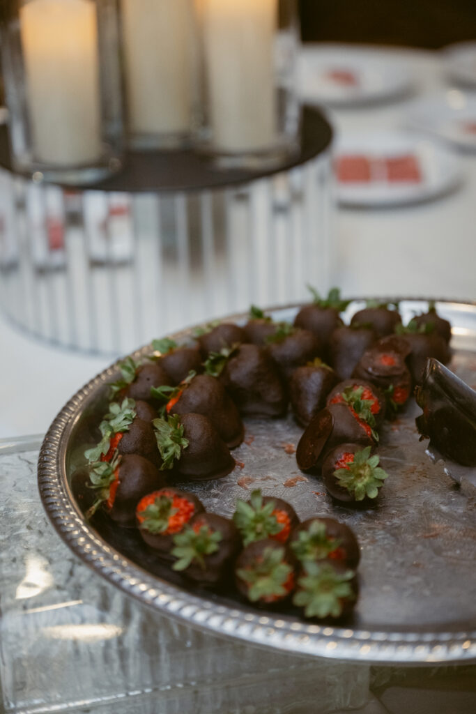 Chocolate-covered strawberries displayed on a dessert tray.