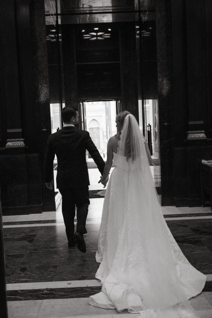 Bride and groom walking hand in hand down the aisle after the ceremony.