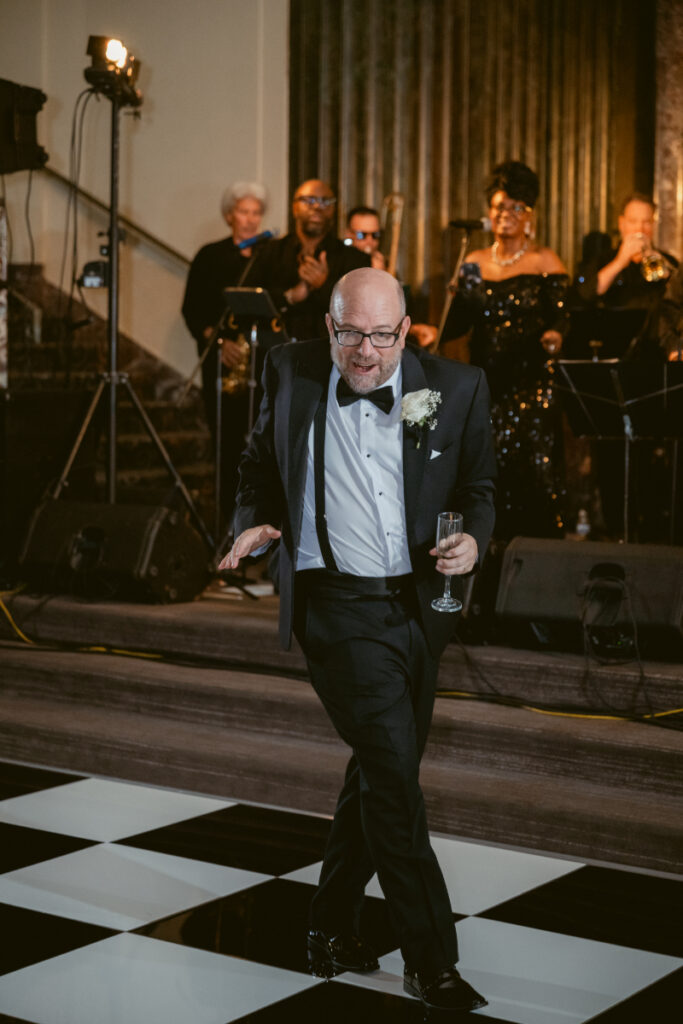 Groom dancing with a guest during the reception.